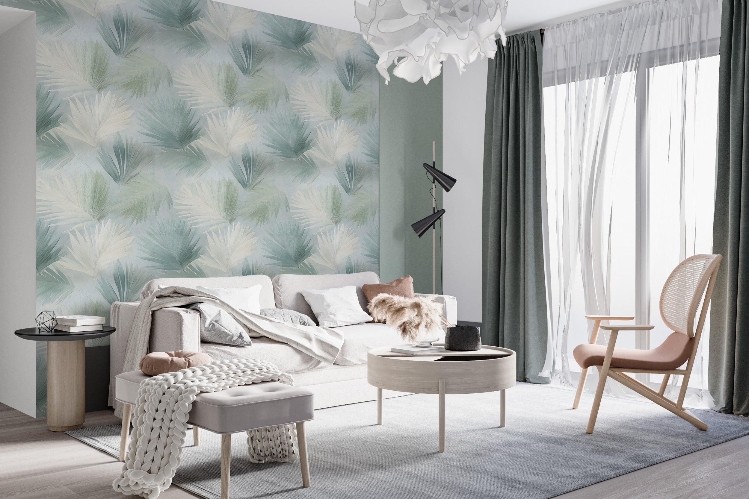 Tropical palm leaves wallpaper in sage green cream shown in a modern living room with a light sofa, soft textiles, and large