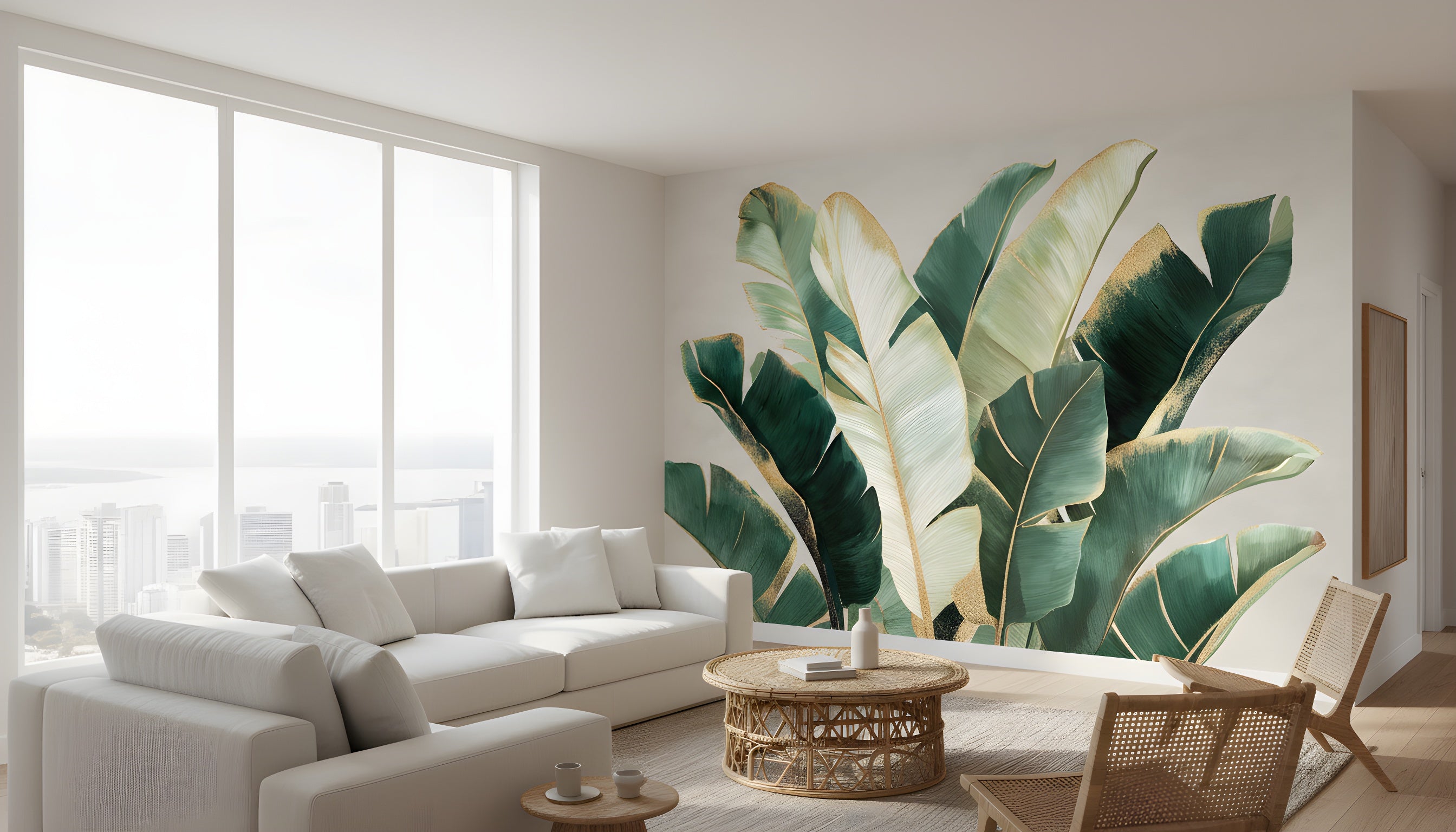 Tropical banana leaf mural in emerald greens and gold accents on a living room wall beside a white sectional sofa and rattan coffee table, modern