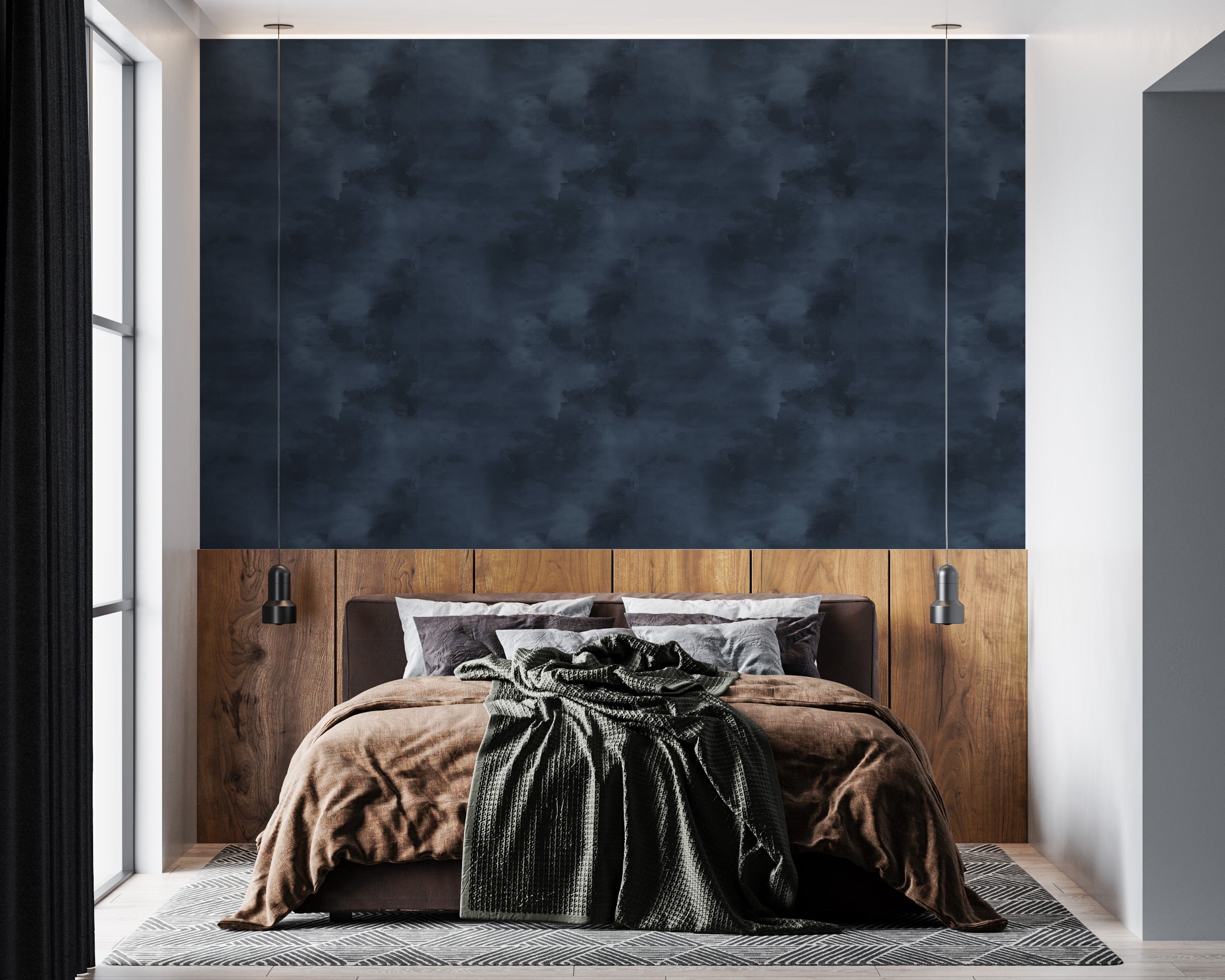 Navy blue abstract textured wallpaper on a bedroom wall behind a wooden headboard with pendant lights, draped bedding in brow