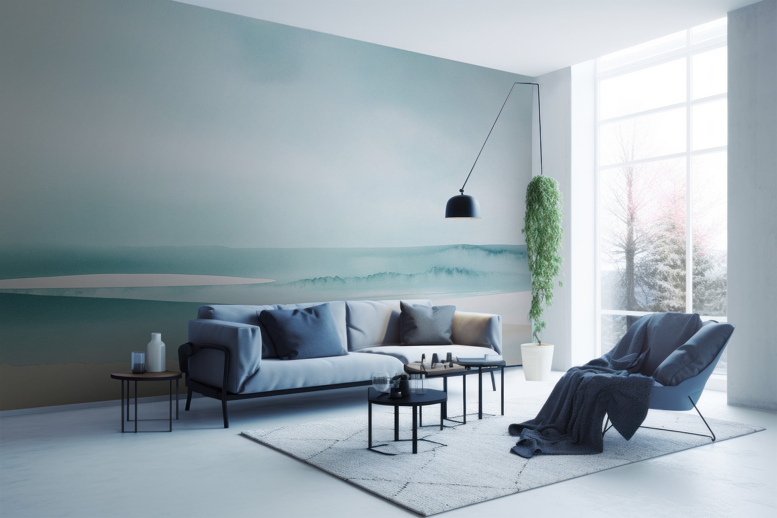 Soft teal beige watercolor ocean waves mural in a calm modern living room with pale blue sofa, black coffee tables, and a tal