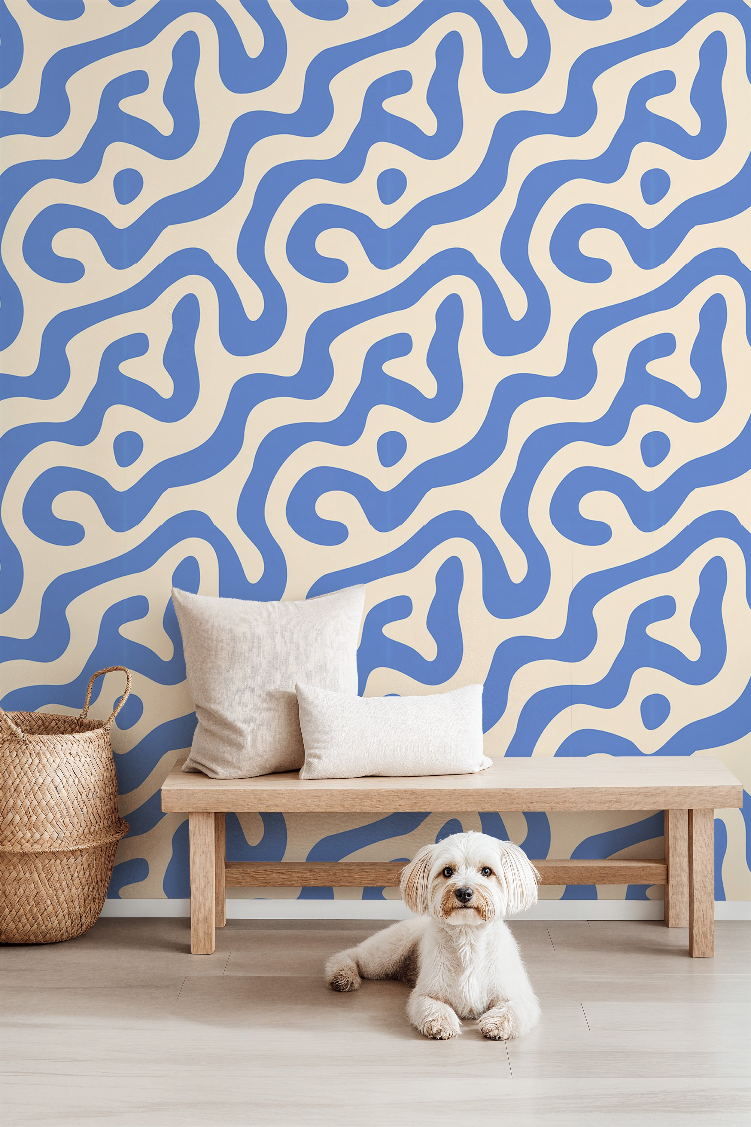 Removable blue beige abstract swirl wallpaper in a modern living room with a wooden bench, cushions, and a small dog
