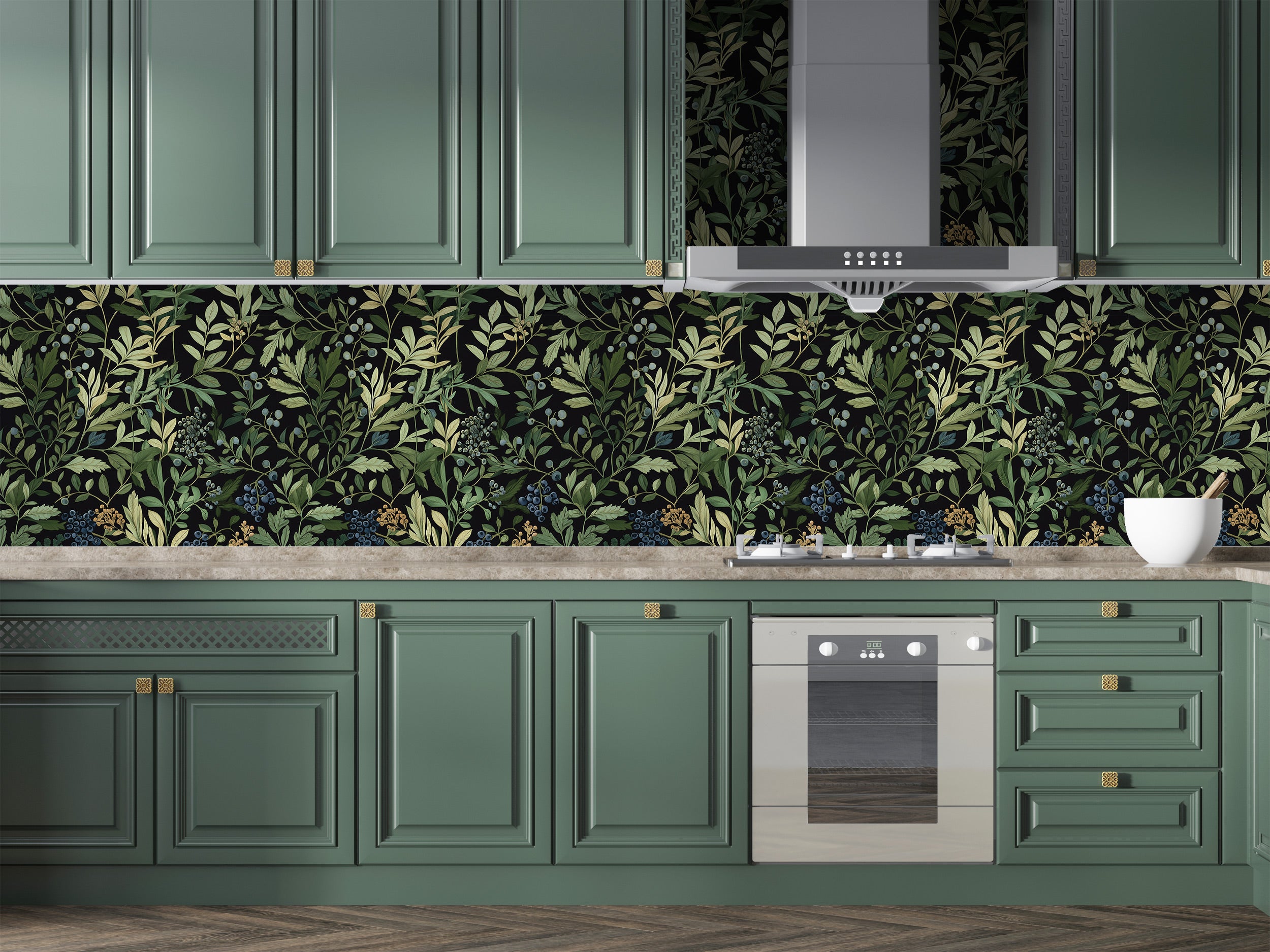 Dark botanical wallpaper with green leaves and berry motifs on a kitchen backsplash behind sage green cabinetry and stainless