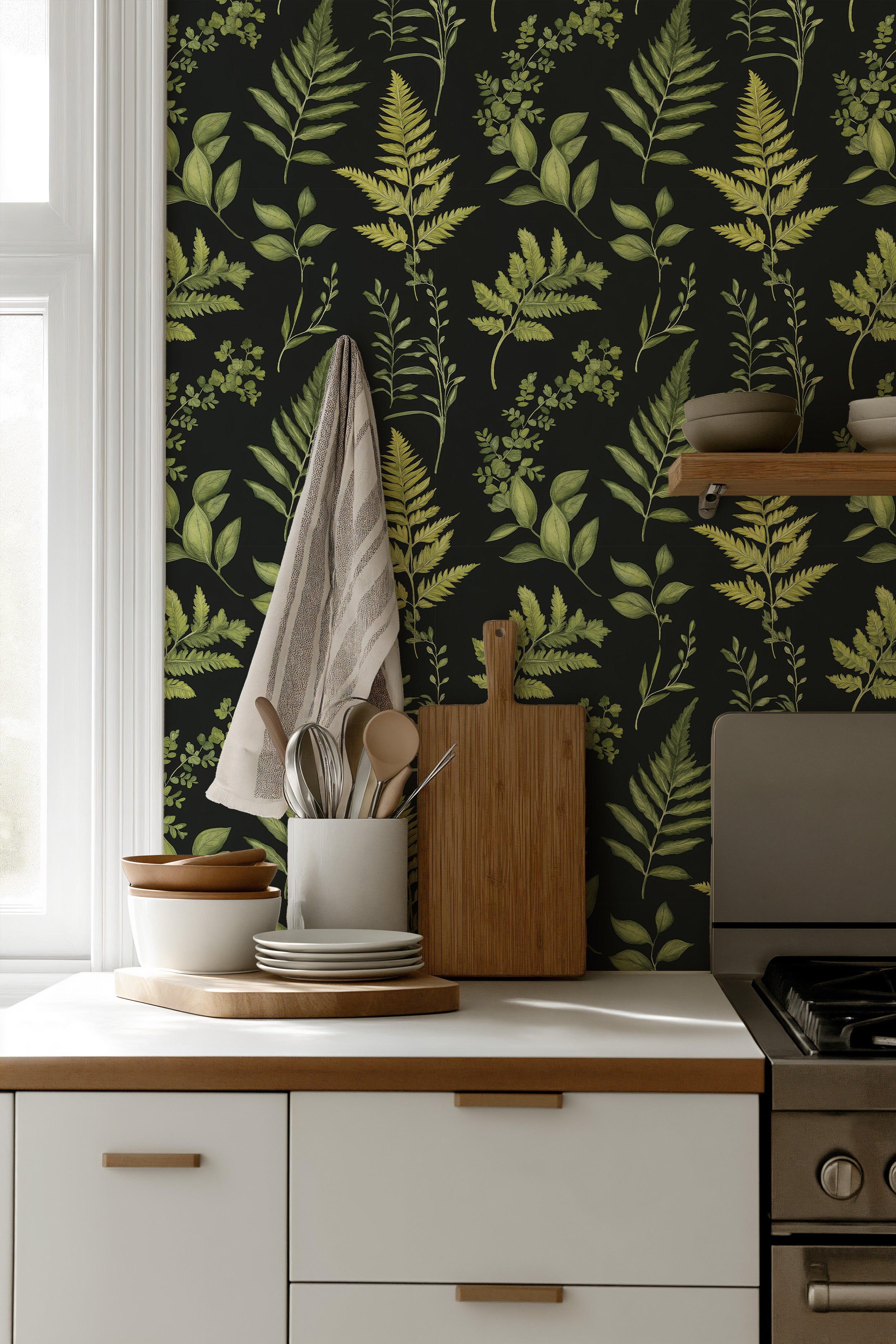 Kitchenscape with black botanical fern wallpaper in green leaves, white cabinets, wood accents and hanging towel for a nature