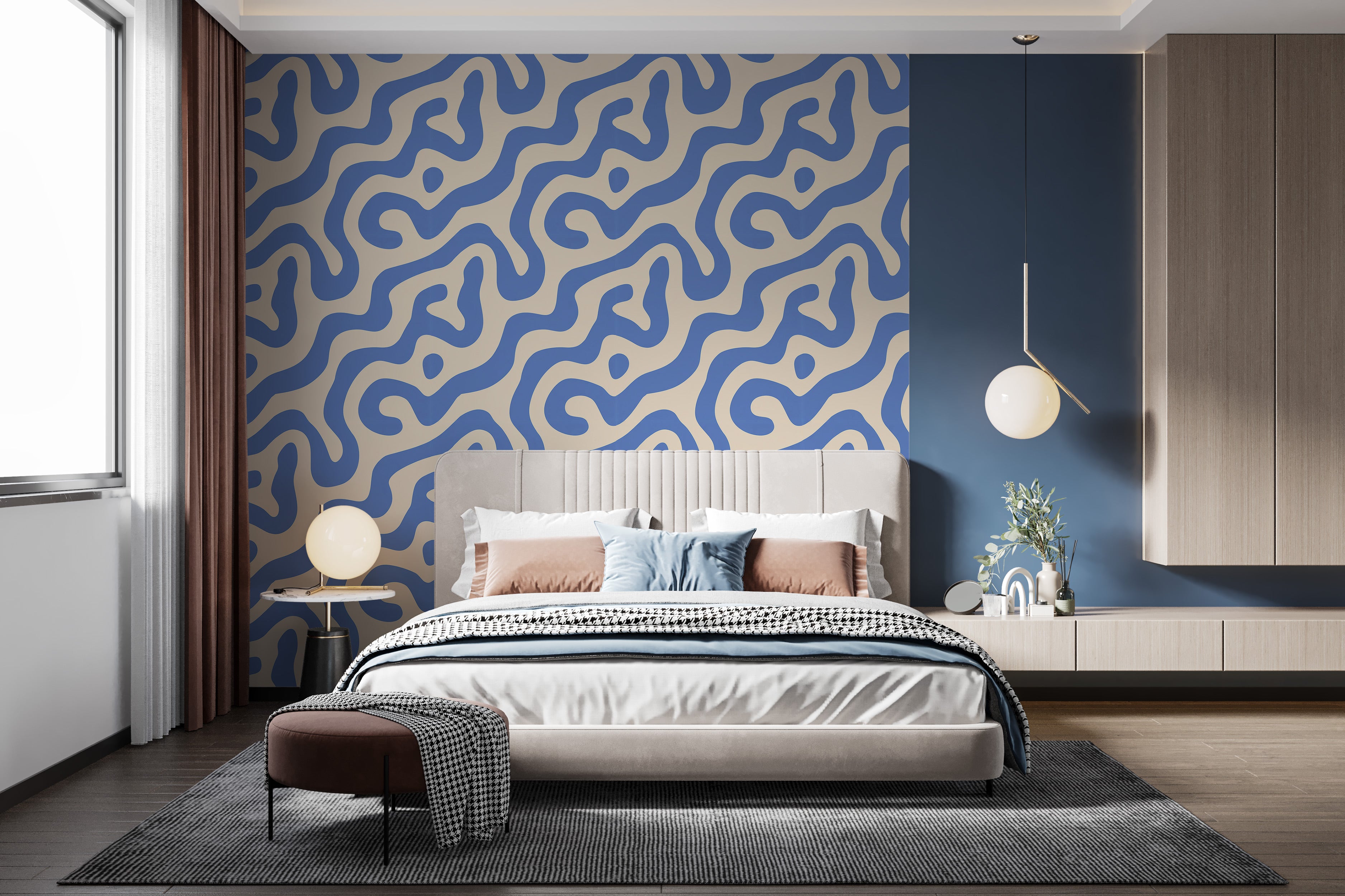 Removable blue beige abstract swirl wallpaper behind a modern tufted gray bed in a chic bedroom setting with blue accent wall