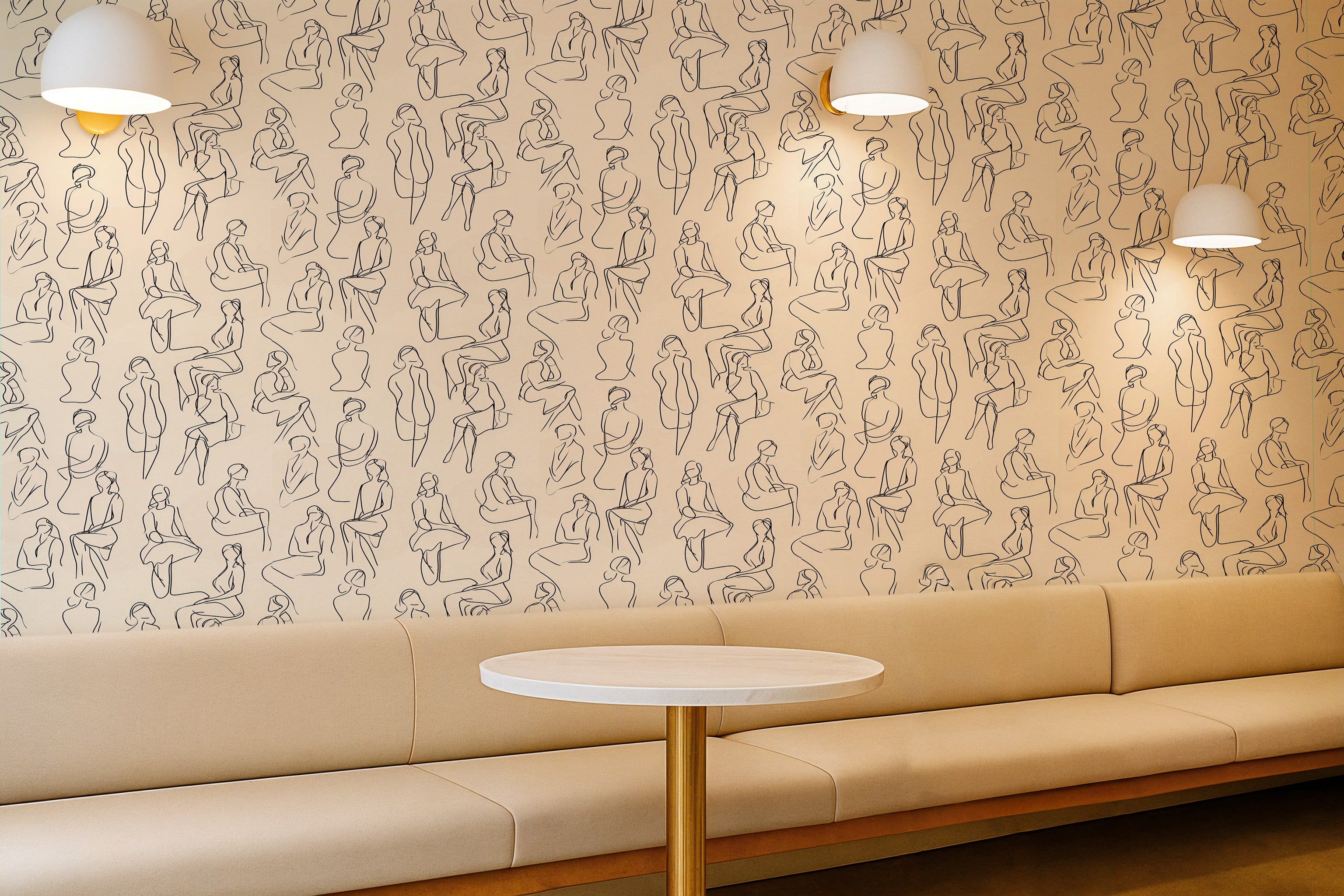 Beige abstract figure wallpaper with black line drawings of seated human silhouettes over a modern lounge with a round table