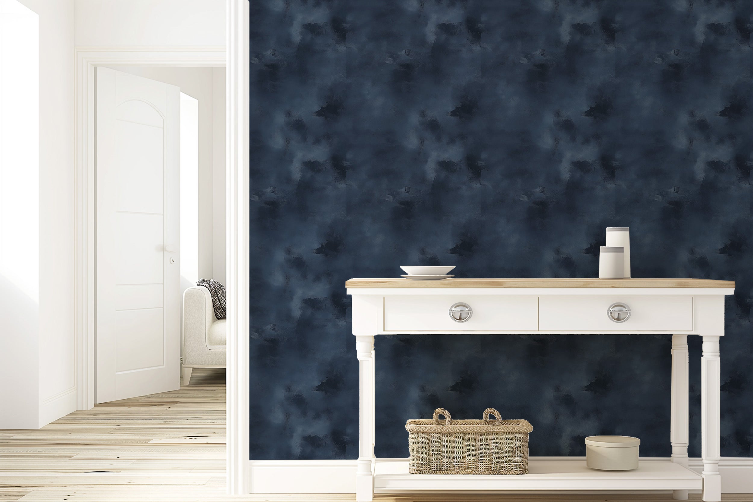 Navy blue abstract texture wallpaper with a cloudy pattern in a modern entryway, accents a white console table and woven bask