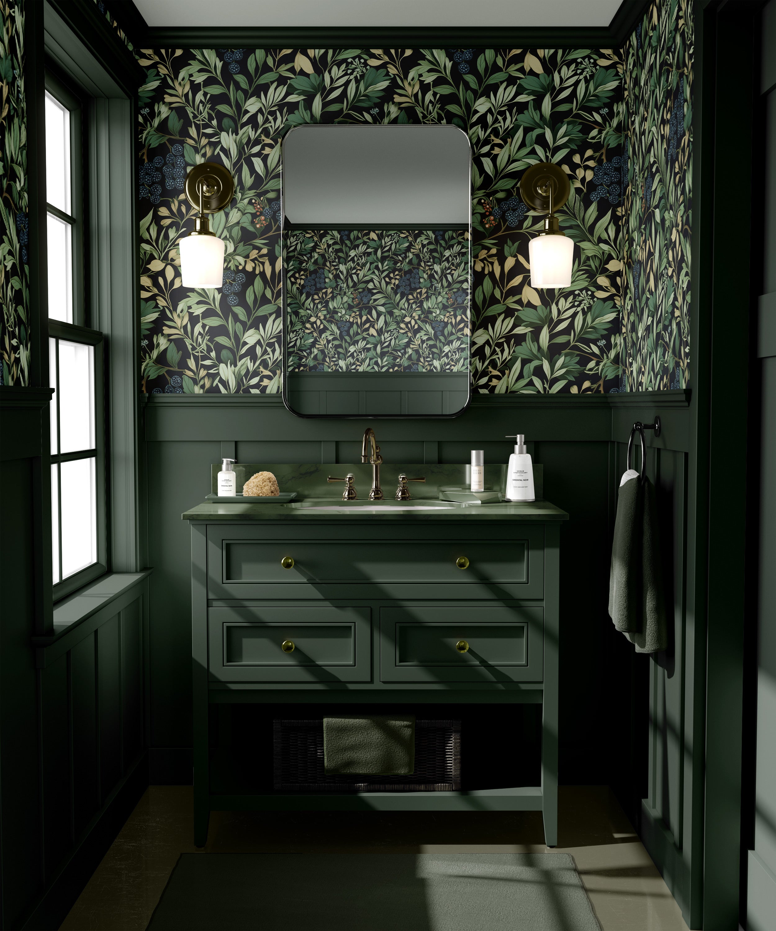 Dark moody bathroom with botanical berry wallpaper, green vanity, brass fixtures, and a framed mirror on a dark leafy backdro