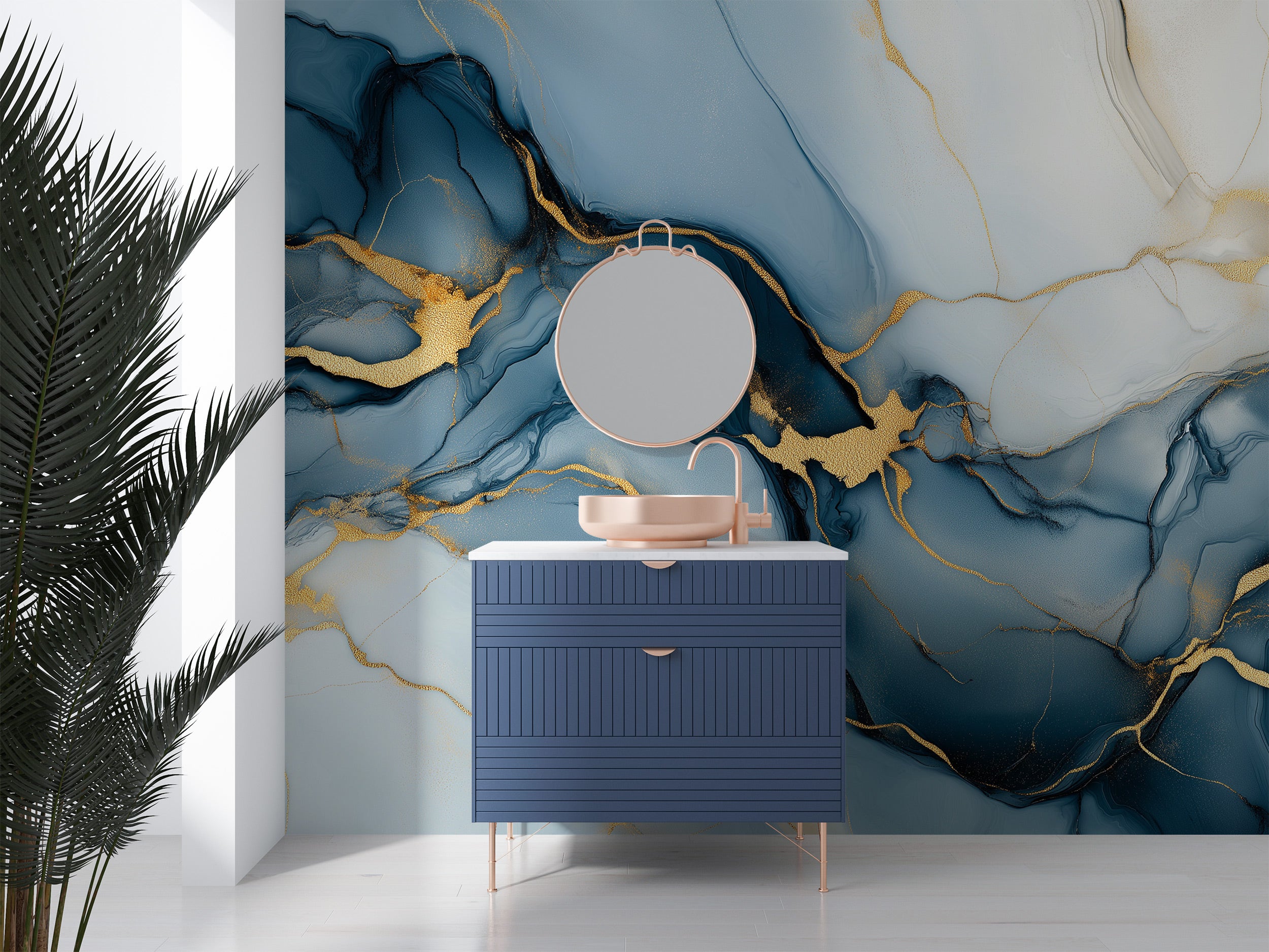 Blue and gold abstract peel-and-stick mural in a modern bathroom vanity area with navy cabinet, round mirror, and pastel blue