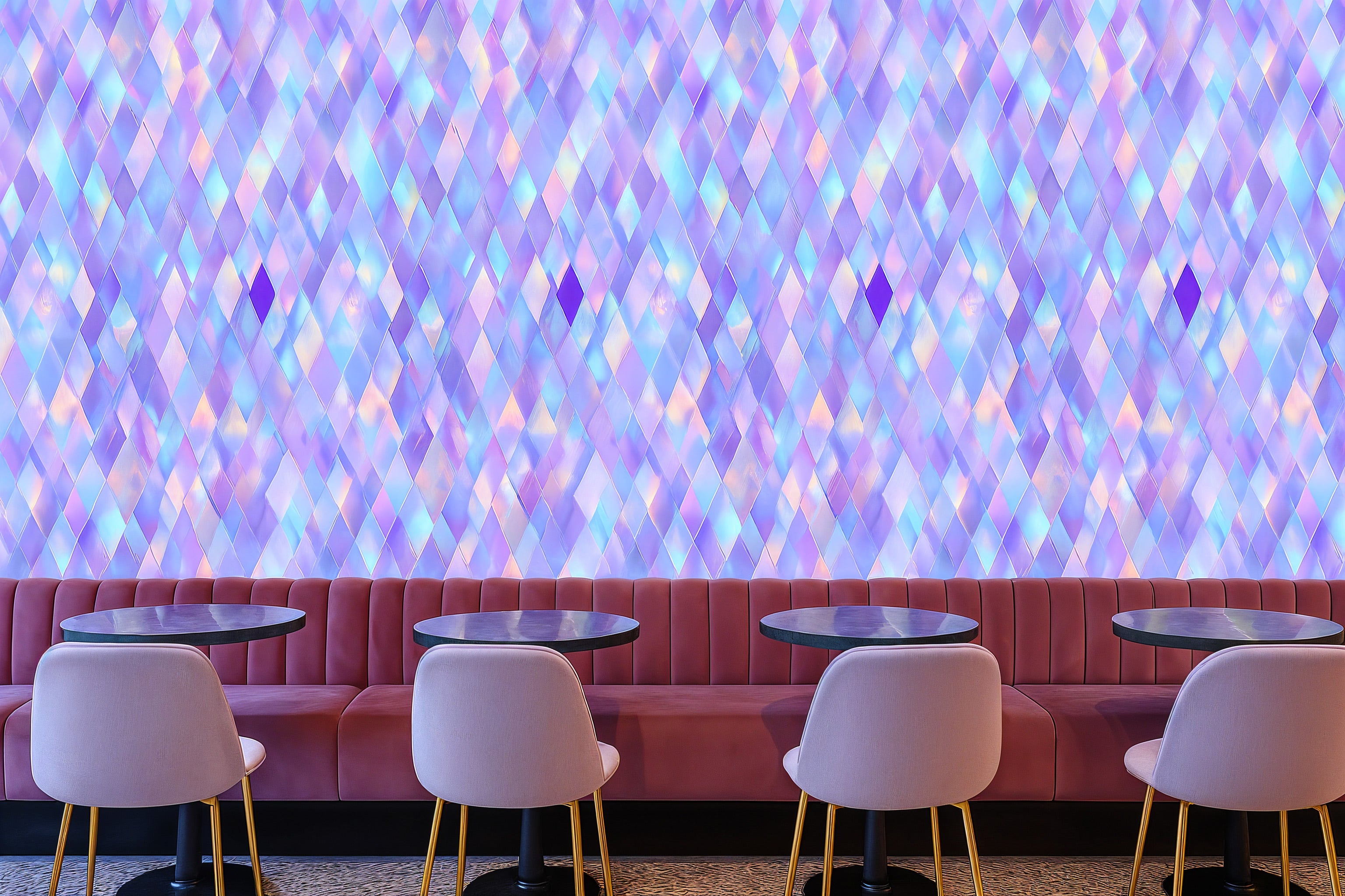 Holographic diamond wallpaper in purple blue pink tones on a dining booth wall with round black tables and light pink chairs