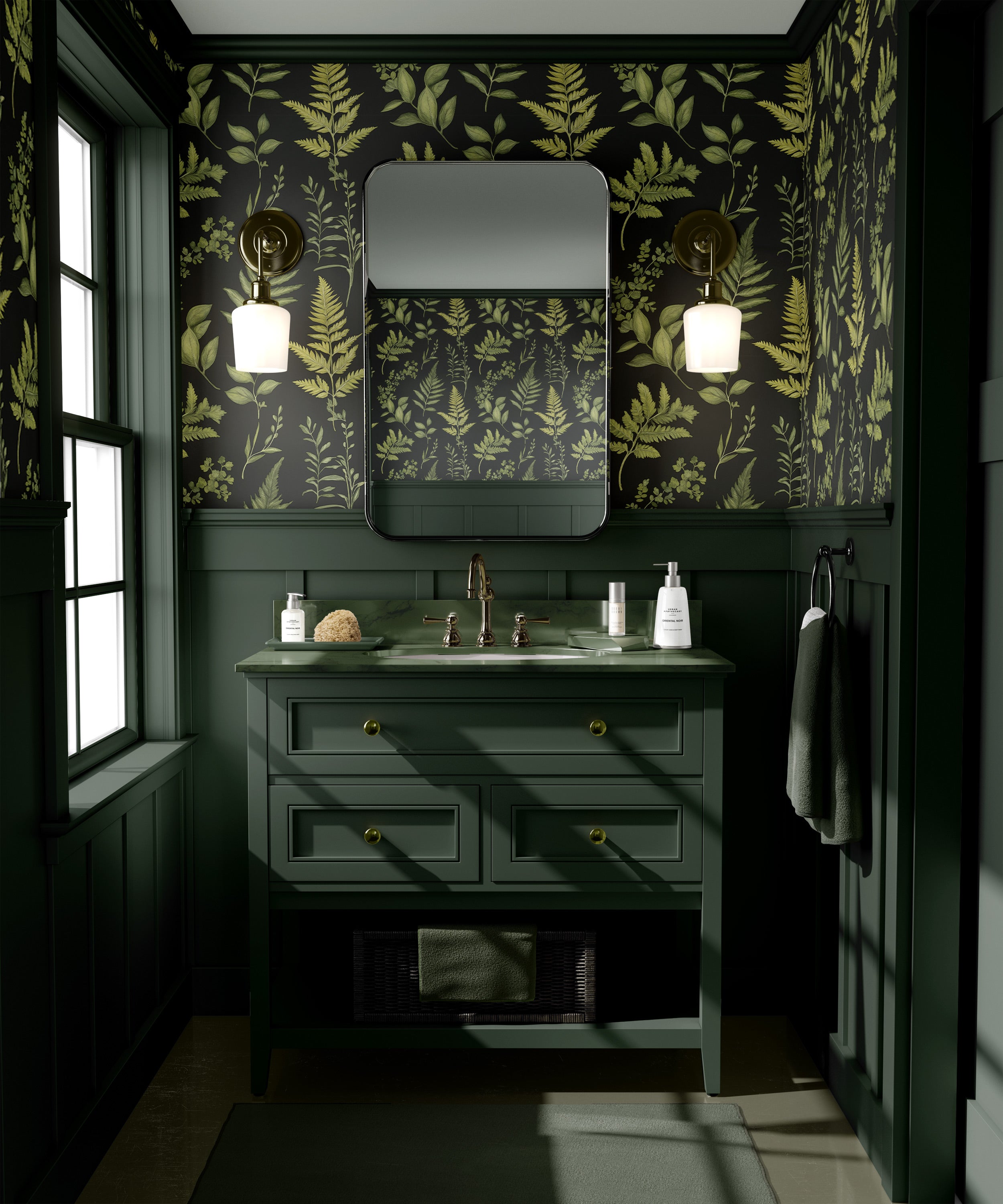 Green botanical fern wallpaper with dark background complements a green vanity with brass hardware and a rounded mirror in a