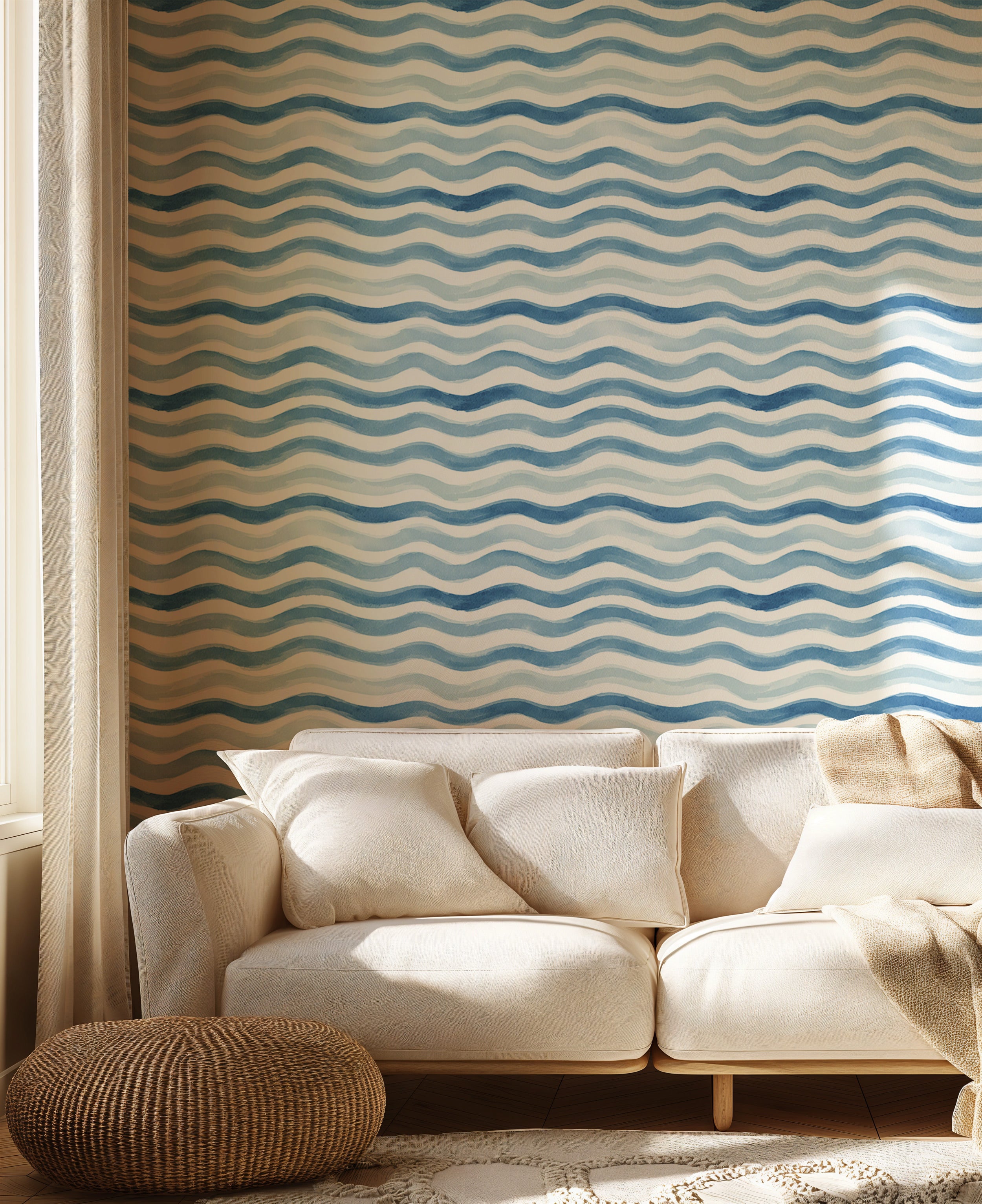 Blue watercolor wave pattern wallpaper with white accents in a coastal living room backdrop on a beige sofa room setting