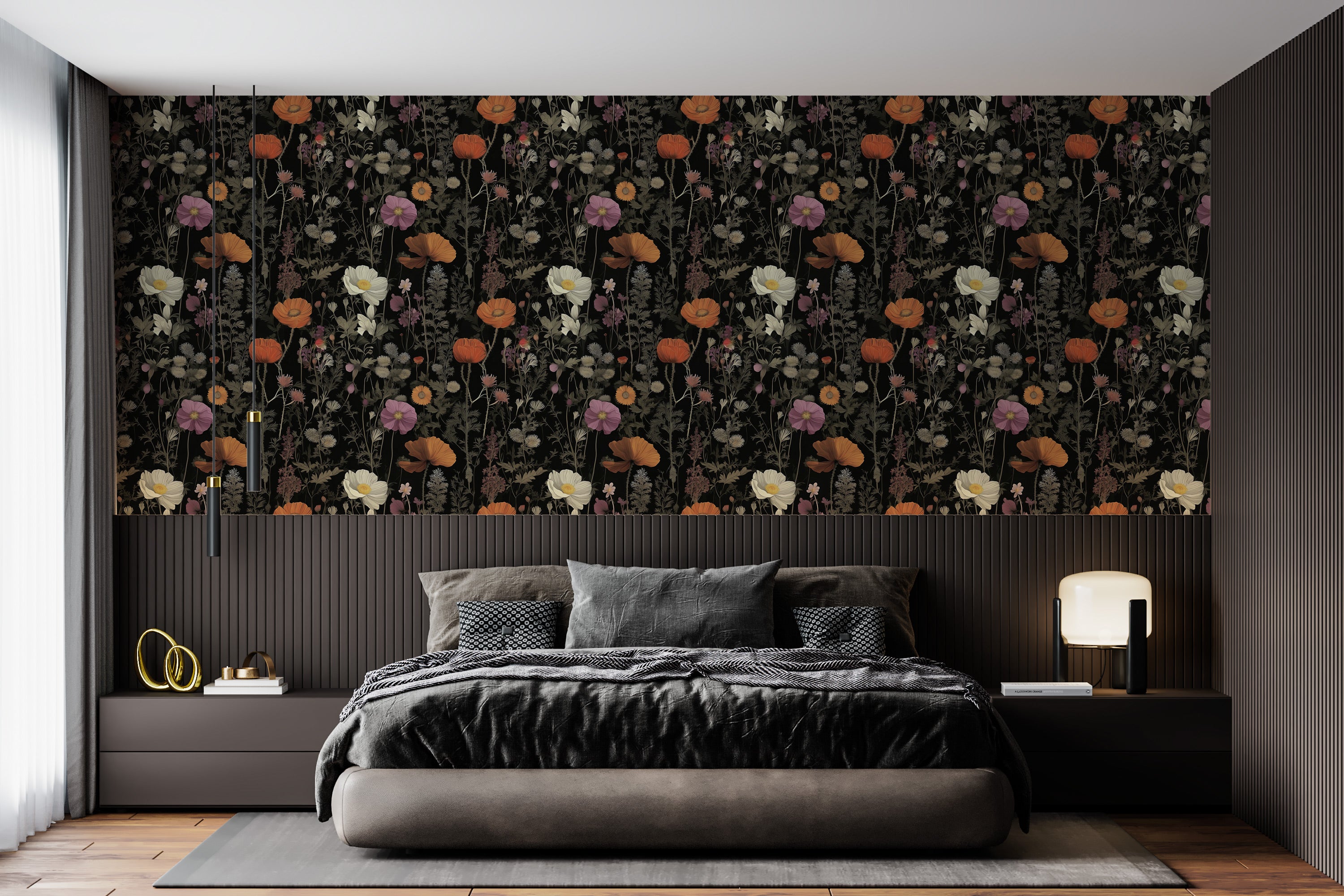 Dark botanical floral pattern wallpaper with orange poppies on a black background shown as a dramatic bedroom accent wall with a low platform bed and