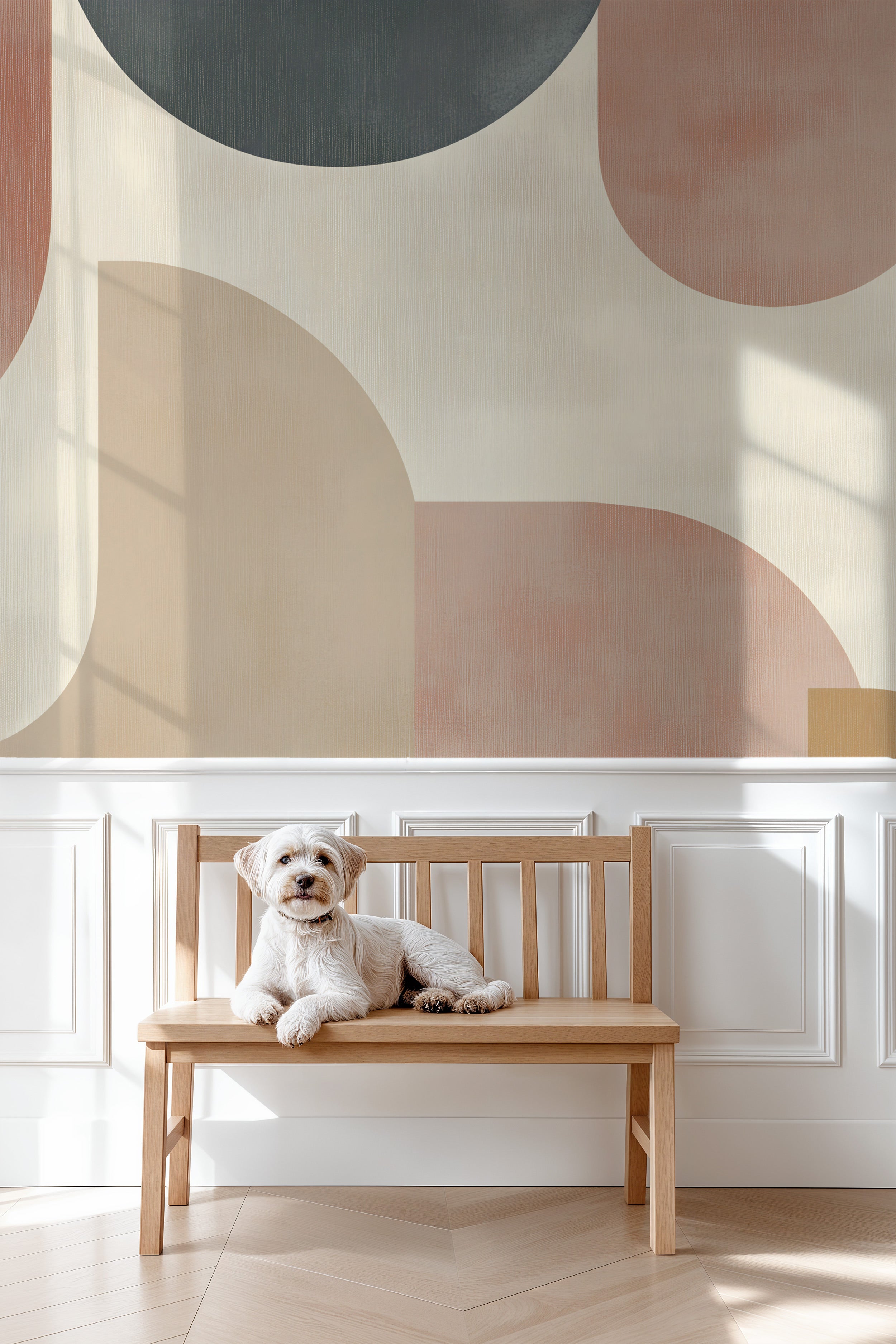 Abstract geometric mural in terracotta charcoal beige tones on white wall behind a wooden bench with a small white dog loungi
