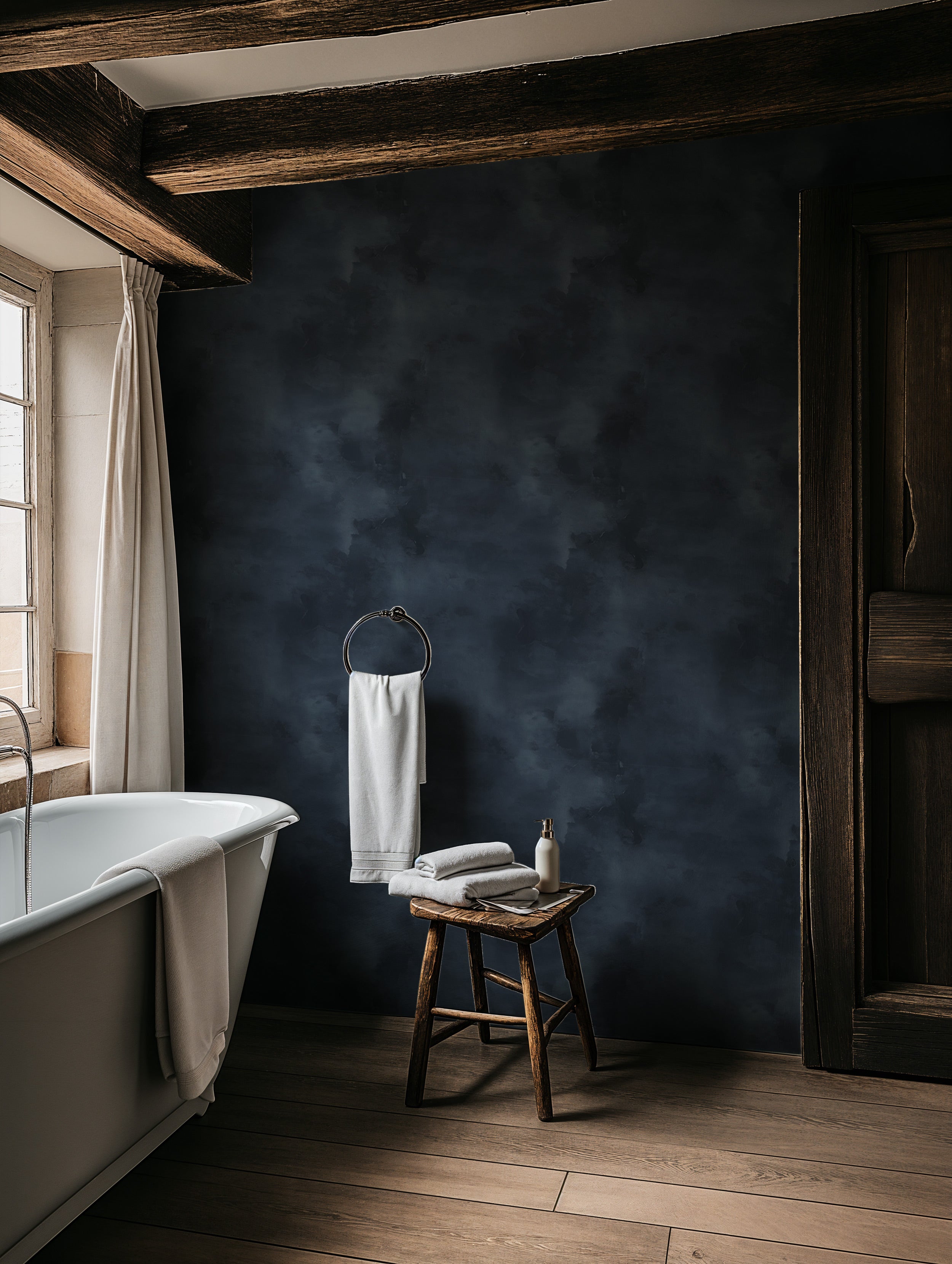 Navy blue abstract textured wallpaper in a bathroom with clawfoot tub, wooden beams, and soft towels for bedroom style decor