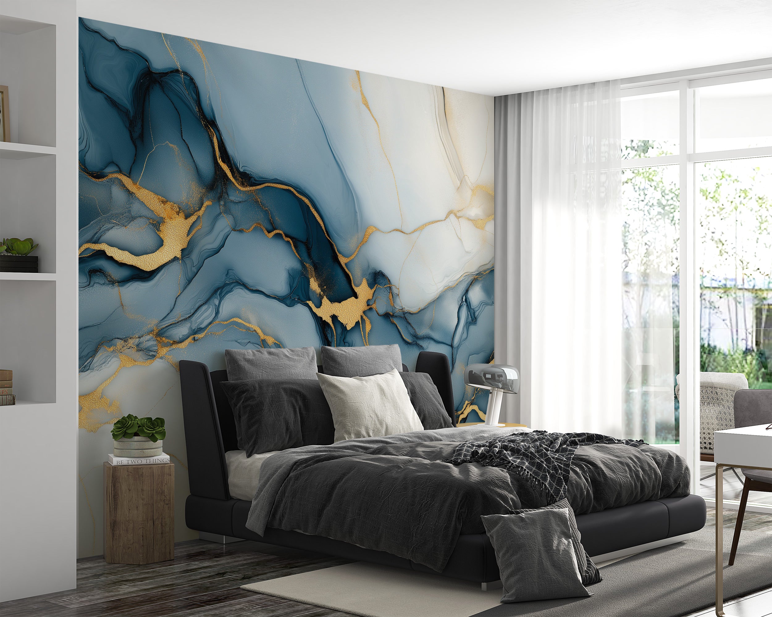 Blue and gold abstract mural with flowing ink-like patterns and luxe gold veining on a navy wall behind a modern black bed in