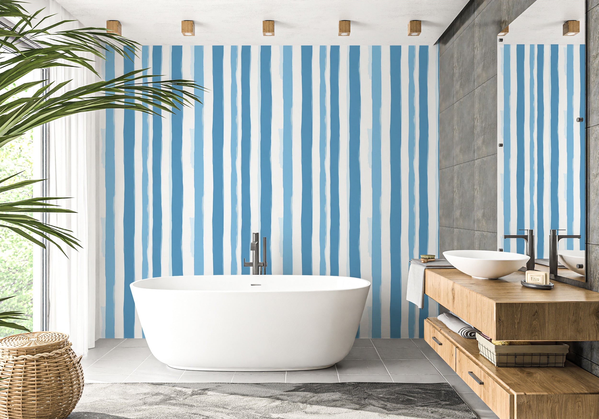 Blue watercolor striped peel and stick wallpaper in a modern bathroom with a freestanding tub and wooden vanity, coastal vert