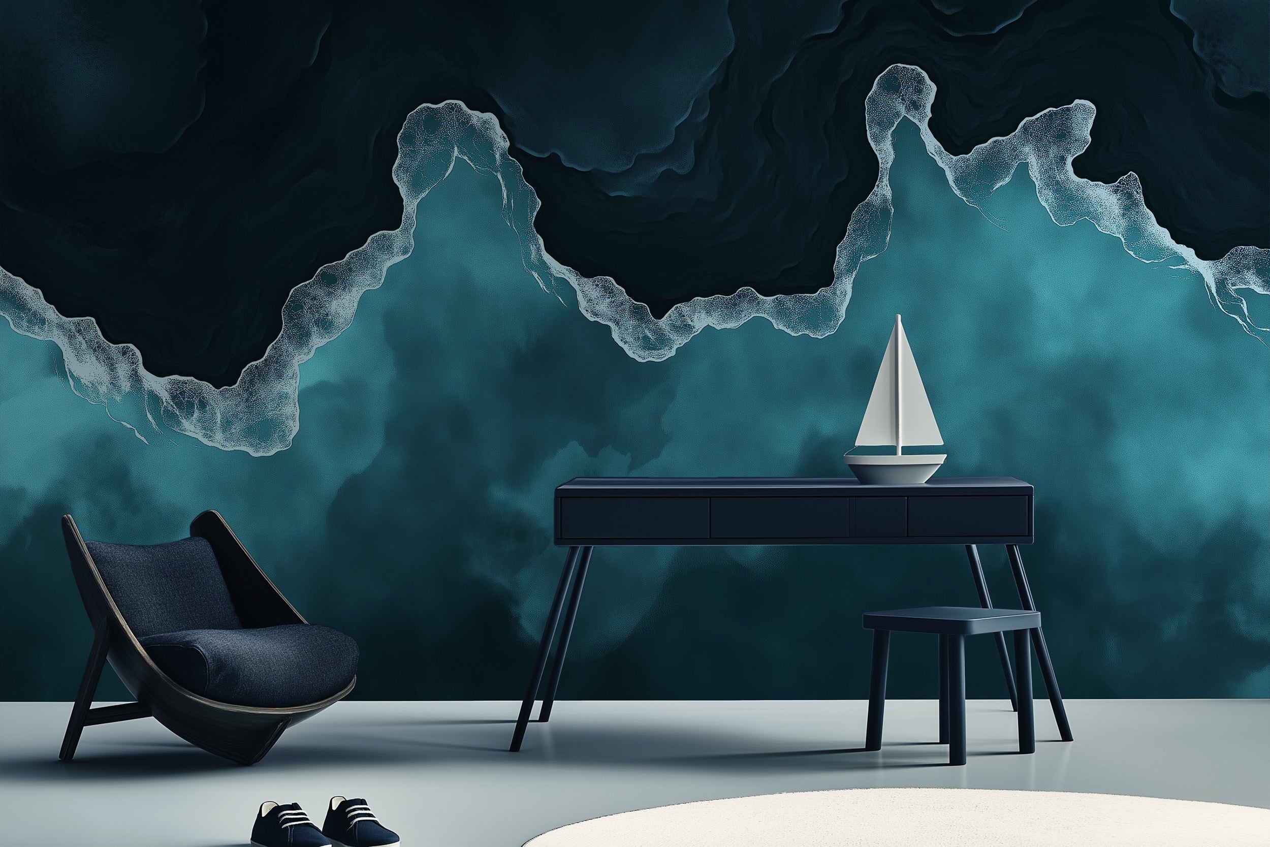 Ocean waves mural in teal and navy blue tones behind a navy desk and chair, coastal decor scene with a small sailboat model o