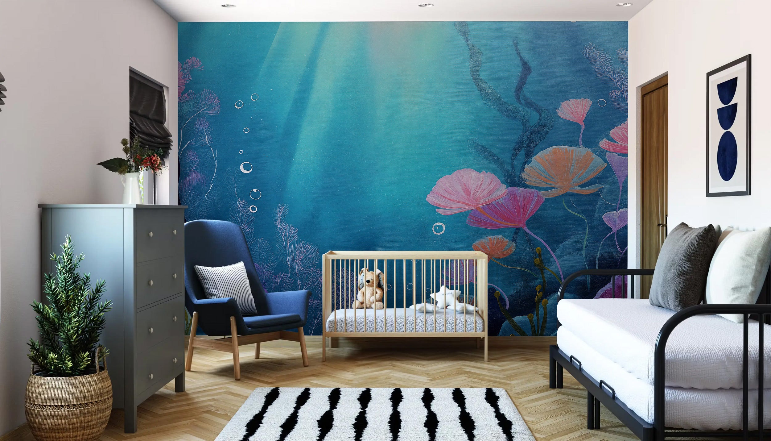 Underwater coral reef mural with vibrant blues, pinks, and tropical fish in a bright bedroom setting with a crib and blue cha