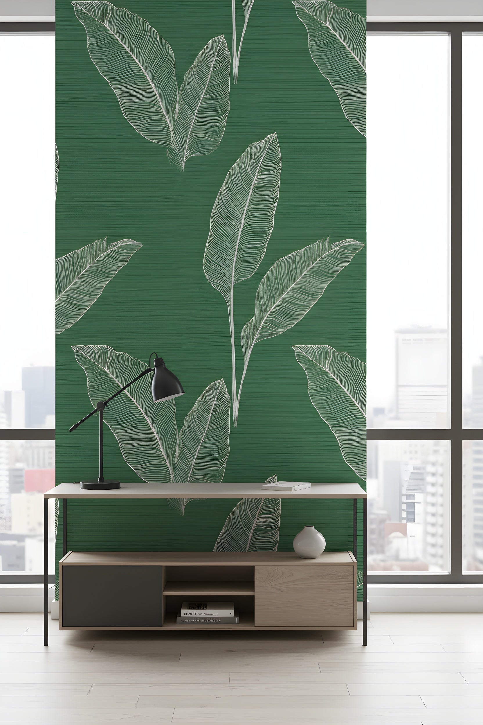 Green tropical leaf wallpaper with white line art showing large white leaves on a rich emerald textured background, stylish home office setup